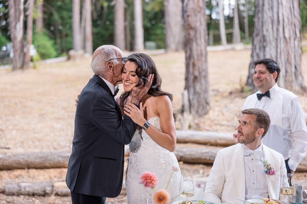 grandfather giving bride a kiss