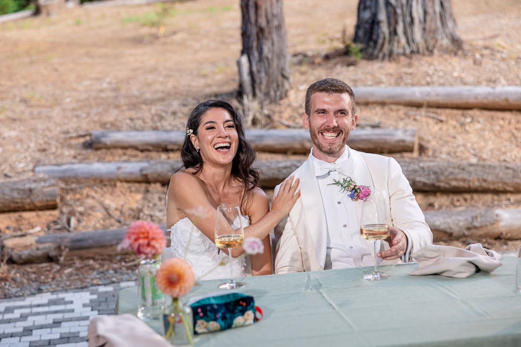 bride and groom laughing during toasts