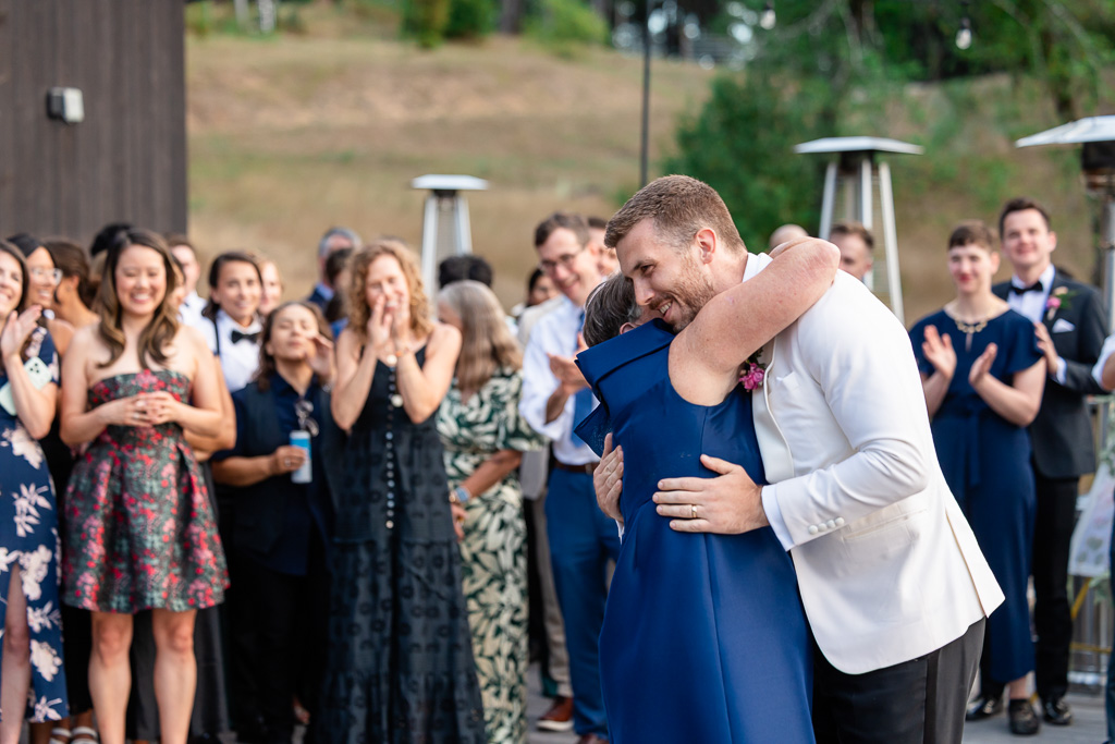 groom and mom hugging