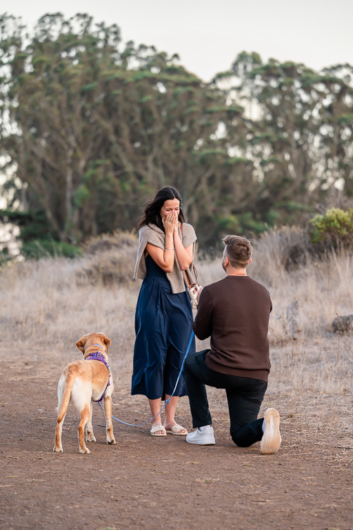 surprise proposal reaction on hiking trail with dog