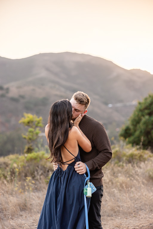 couple kissing under the soft golden hour light in Marin County