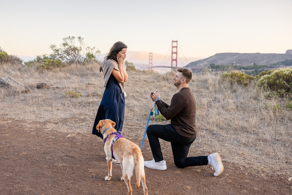 surprise proposal on trail above Cavallo Point with the Golden Gate Bridge in the background