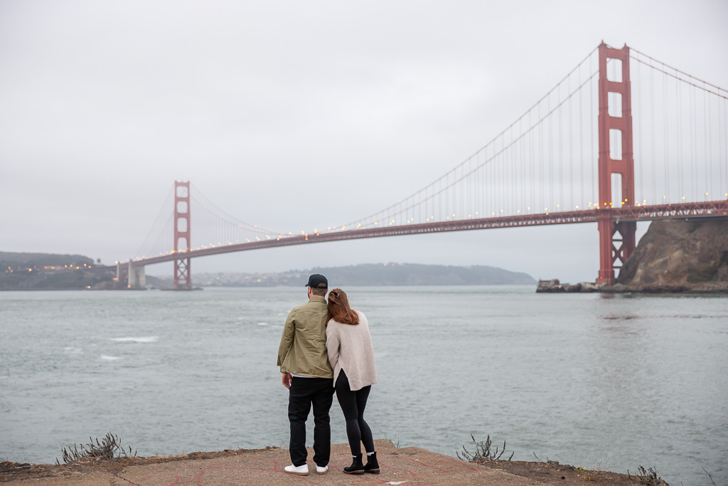sneaky papparazzi photo of couple looking towards the Golden Gate Bridge