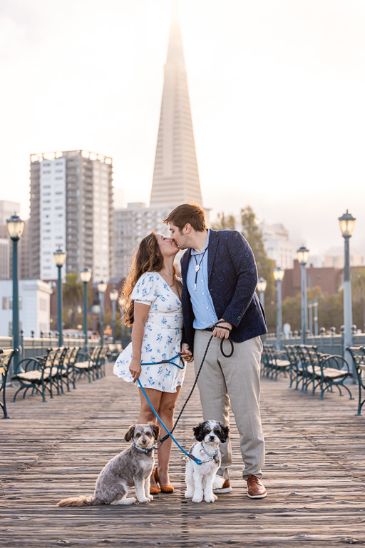 engagement shoot with couple and dogs on wooden pier