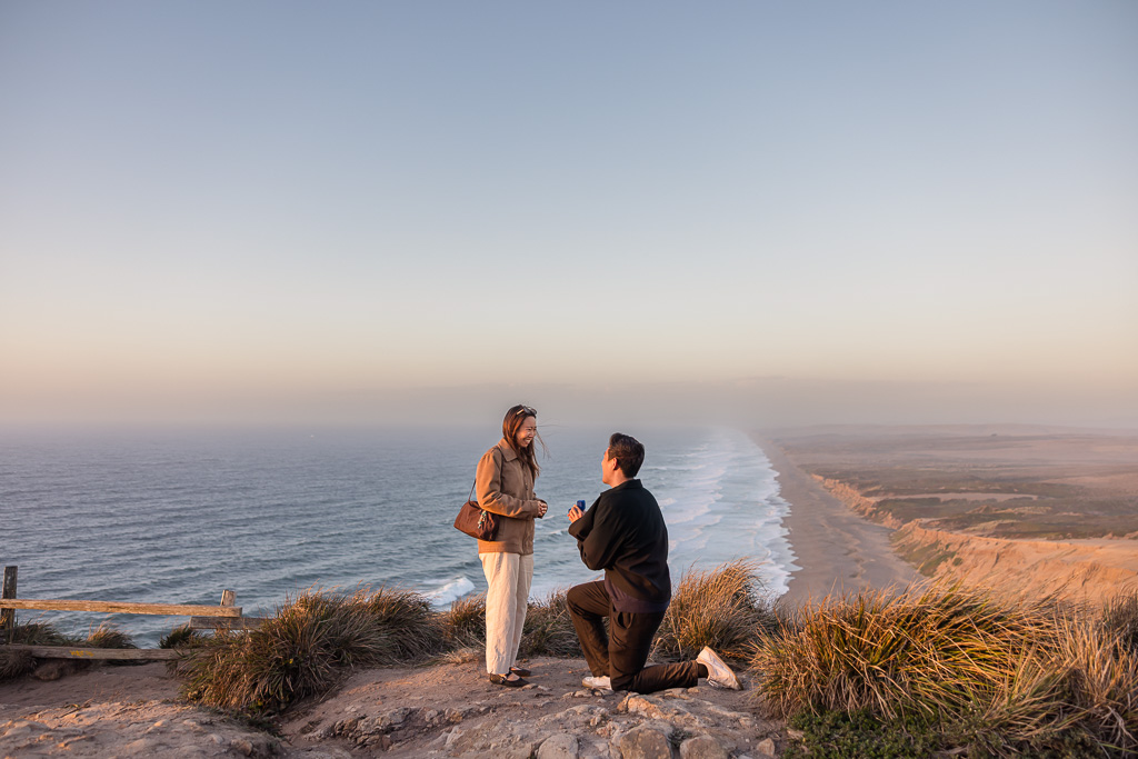 A man surprises his partner with a proposal at the Point Reyes South Beach Overlook