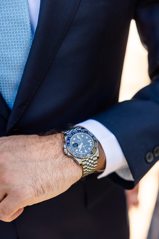 Close-up of the groom’s watch and navy suit cuff
