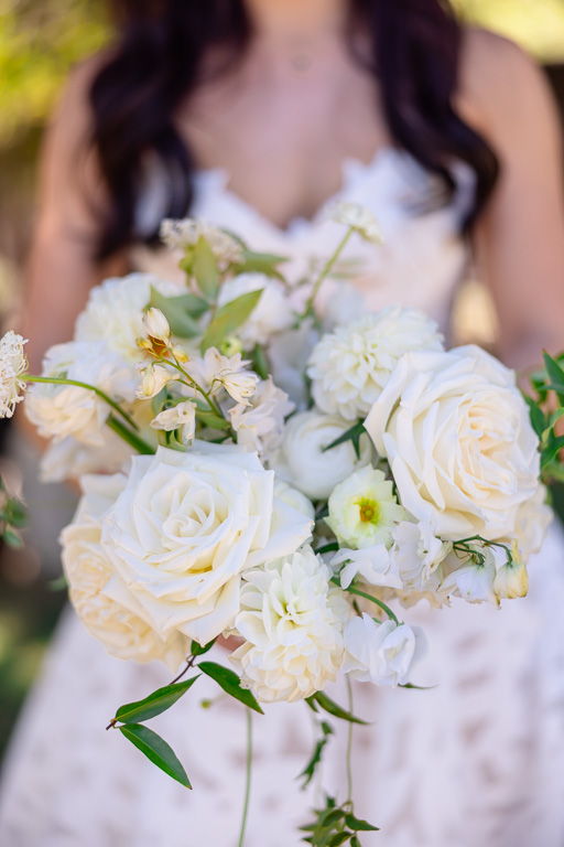 White roses and greenery in the bride’s bouquet