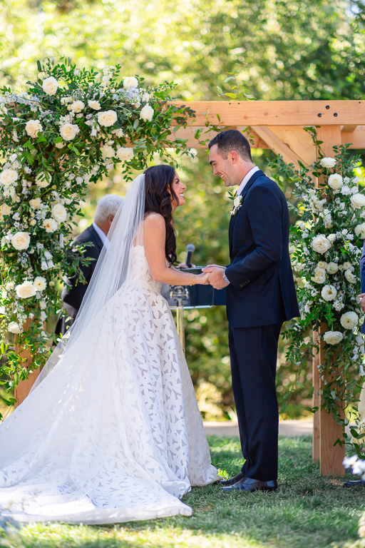 Couple stands together during their outdoor wedding ceremony at the Creekside Lawn