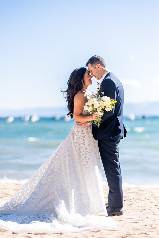 Bride and groom touch foreheads in a Lake Tahoe beach wedding portrait