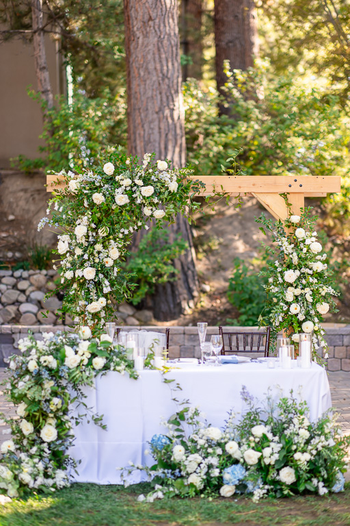 Floral arch frames the reception table at Hyatt Regency Lake Tahoe Resort