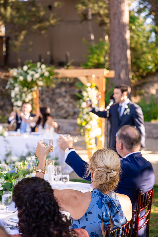parents of the groom raise their glasses as the father of the bride finishes his speech