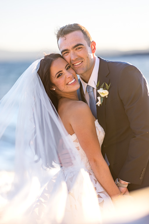 Bride and groom pose together in the romantic evening light at Lake Tahoe