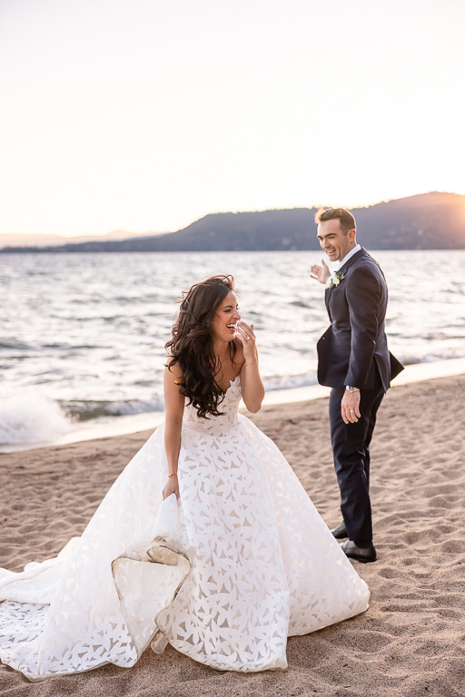 a funny candid moment between the bride and groom as they smile together beside Lake Tahoe