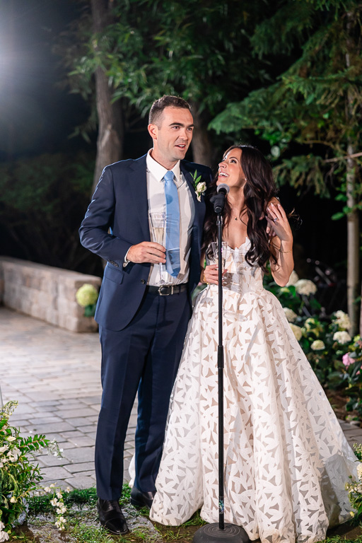 Bride and groom delivering thank-you speech at the reception microphone