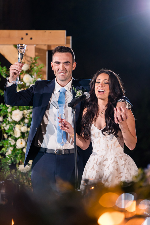 Bride and groom toasting to the guests