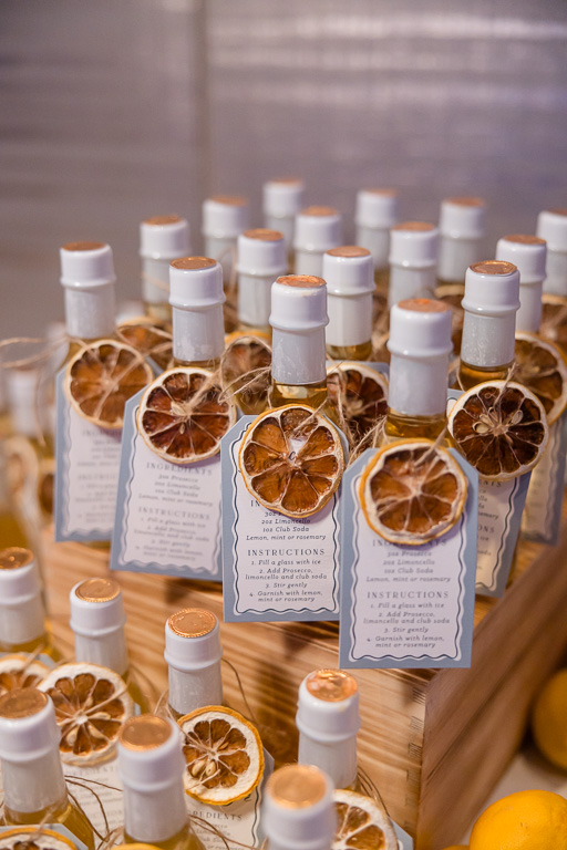 Bottled citrus cocktail favors arranged for wedding guests