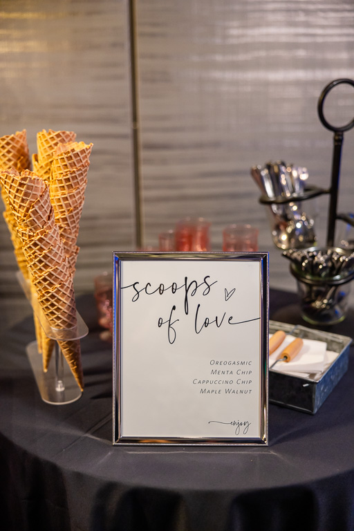 Dessert table and handwritten sign at the wedding reception