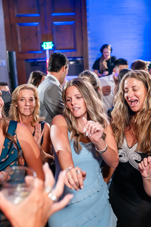 Wedding guests dance together in a lively crowd