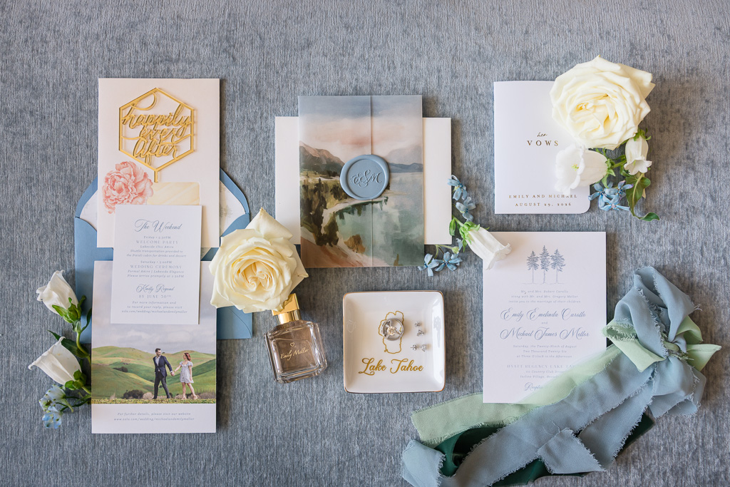 Wedding invitation and day-of stationery arranged with flowers