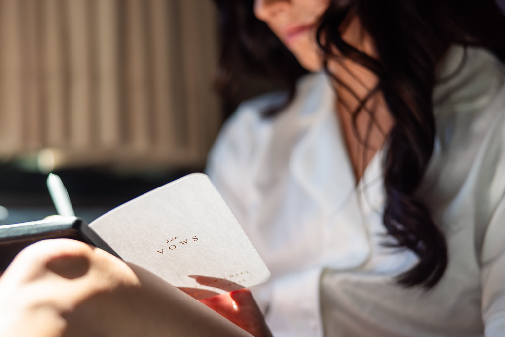 Bride writes her wedding vows while getting ready