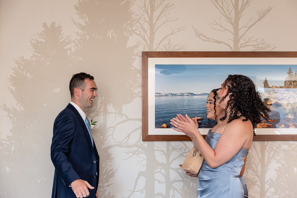 Groom first look with his two sisters