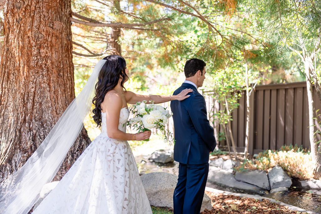 Bride taps her father on the shoulder for a first-look moment