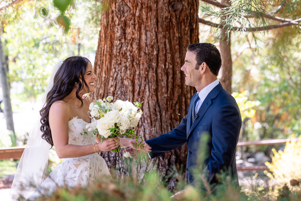 Bride and father pose together in a garden wedding portrait