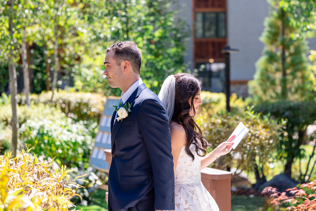 Bride reads her private vows while standing back to back with the groom