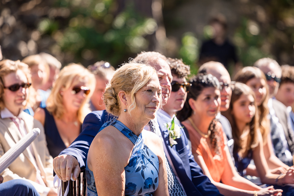 parents of the groom listen intently during the outdoor wedding ceremony