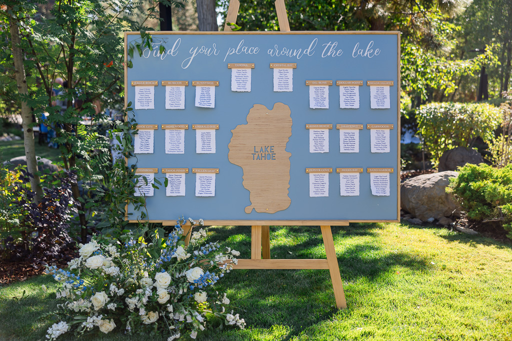Wedding seating chart displayed among the trees at Hyatt Regency Lake Tahoe Resort