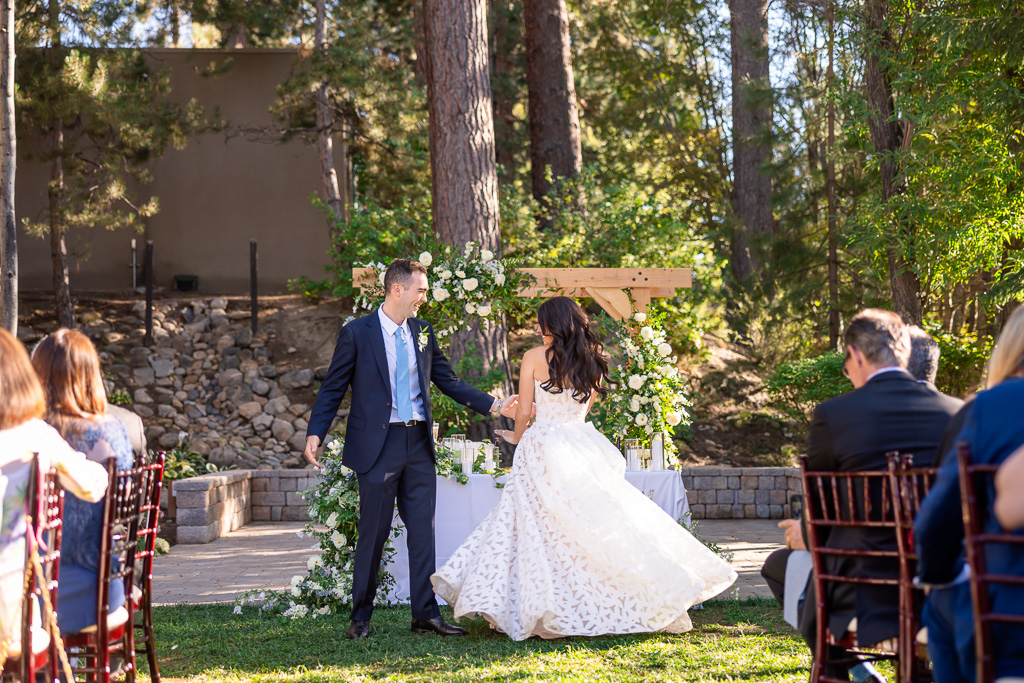 groom spinning the bride near the end of their outdoor first dance in the woods