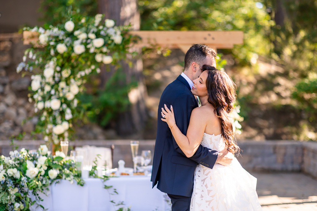 Bride and groom first dance at their Hyatt Regency Lake Tahoe Resort wedding reception on the Creekside Lawn