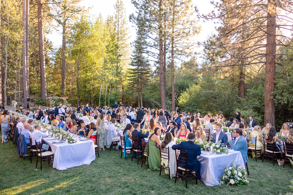 Long wedding reception tables beneath the pines at Hyatt Regency Lake Tahoe Resort