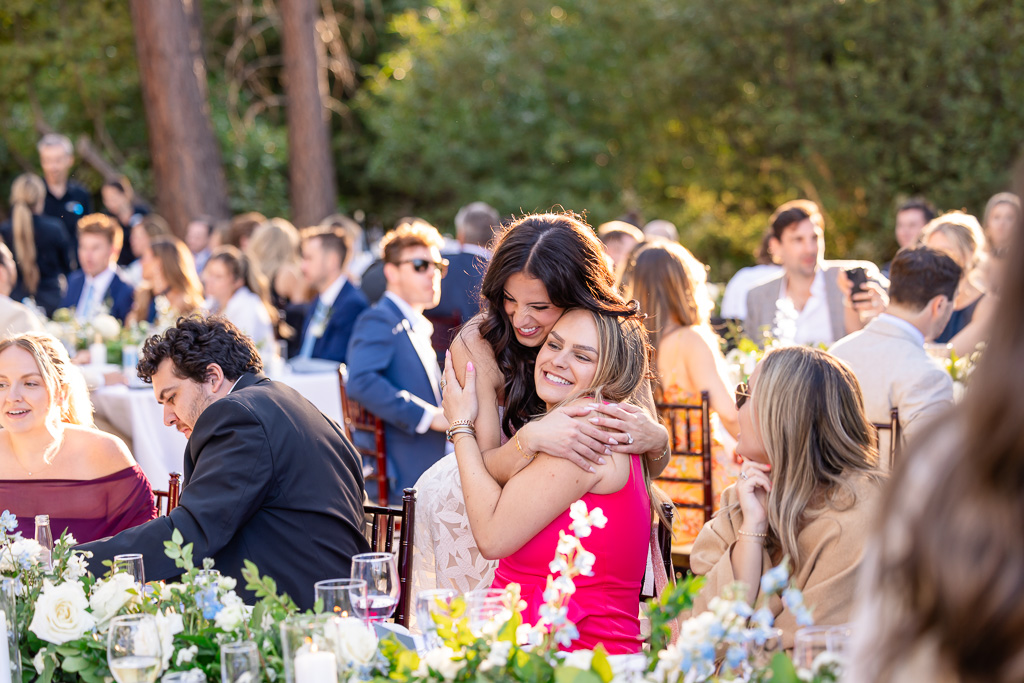 Bride embraces a guest during the wedding reception