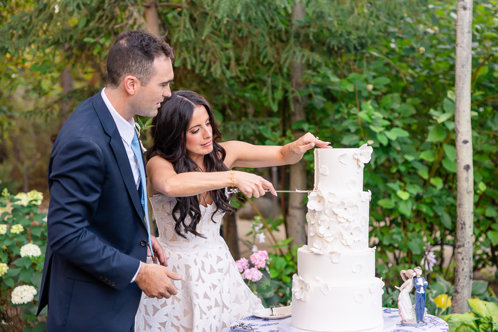 Bride and groom cut their wedding cake together