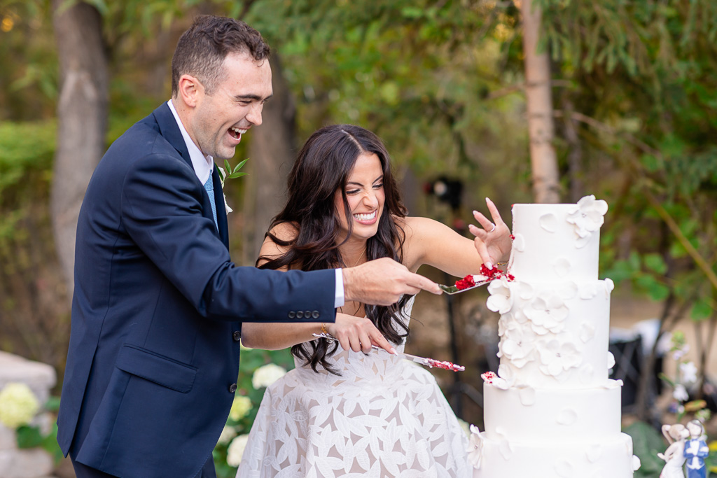 a precious moment as the bride and groom encounter a hiccup cutting their wedding cake