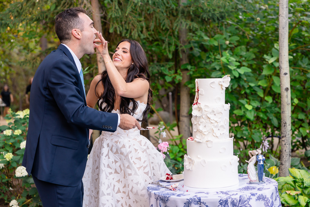 Bride feeds the groom a bite of wedding cake