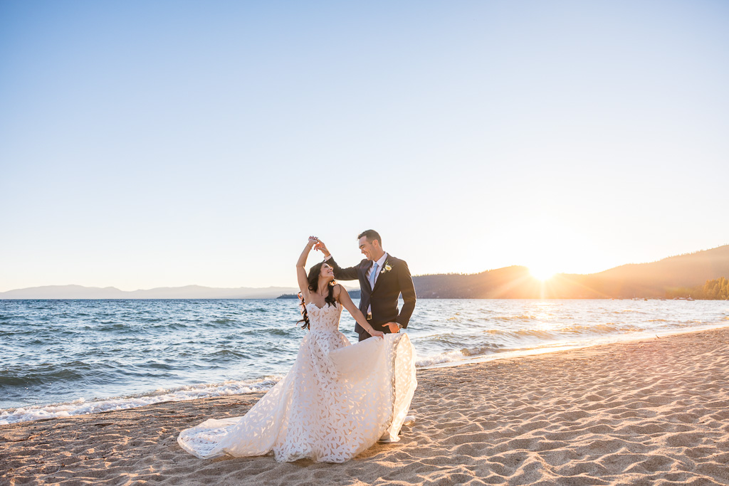 Wedding photo of bride twirling with the groom at Lake Tahoe during sunset