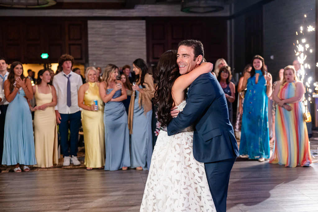 Bride dances with her father as friends celebrate around them