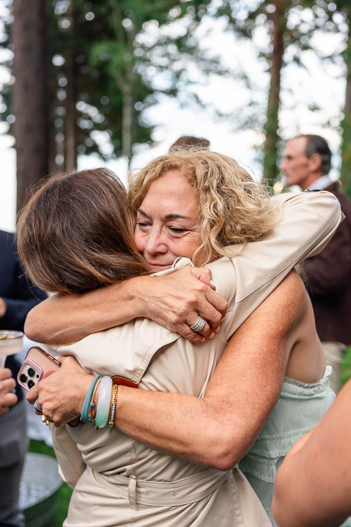Mother of the groom embraces a guest