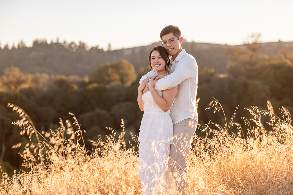 golden hour grassy engagement photos