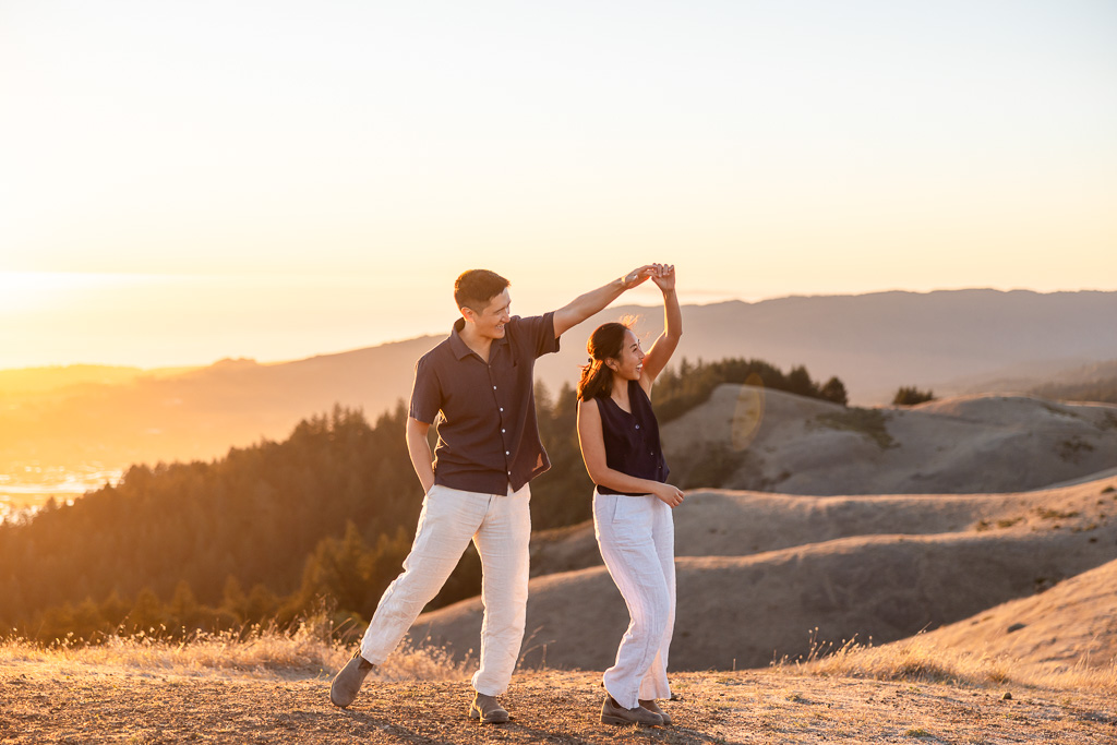 Dancing and twirling on the hills of Marin County during a sunset engagement photo session