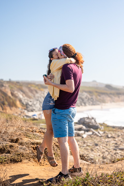 girl being picked up after saying yes to proposal