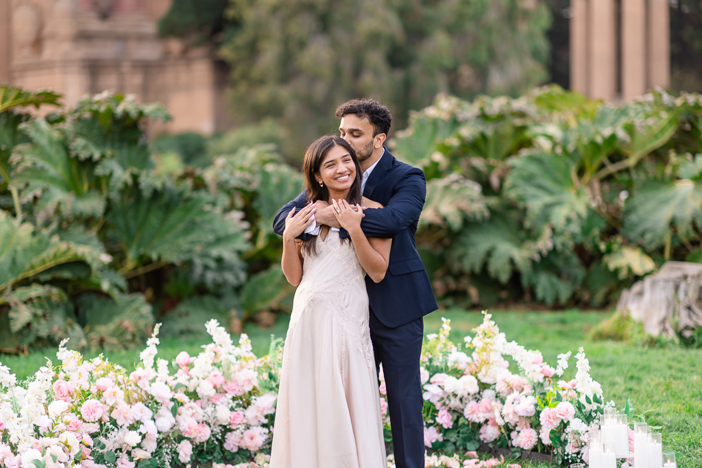 sunset engagement shoot at Palace of Fine Arts with a flower setup on the lawn